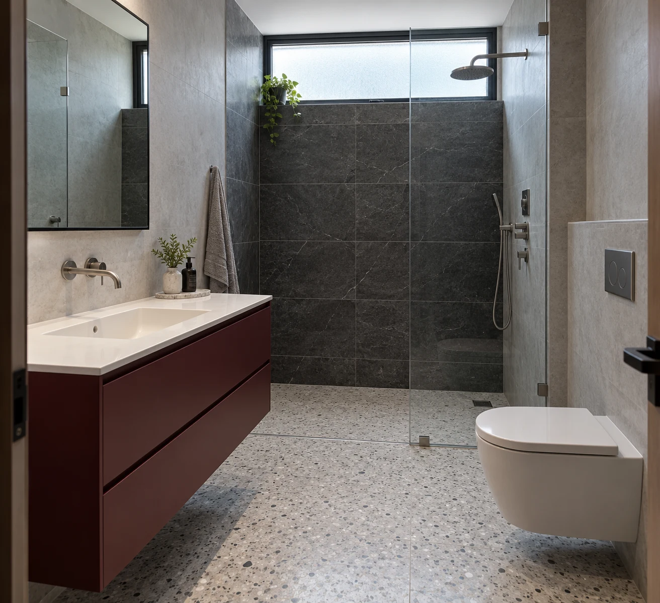 Charcoal bathroom with a burgundy floating vanity